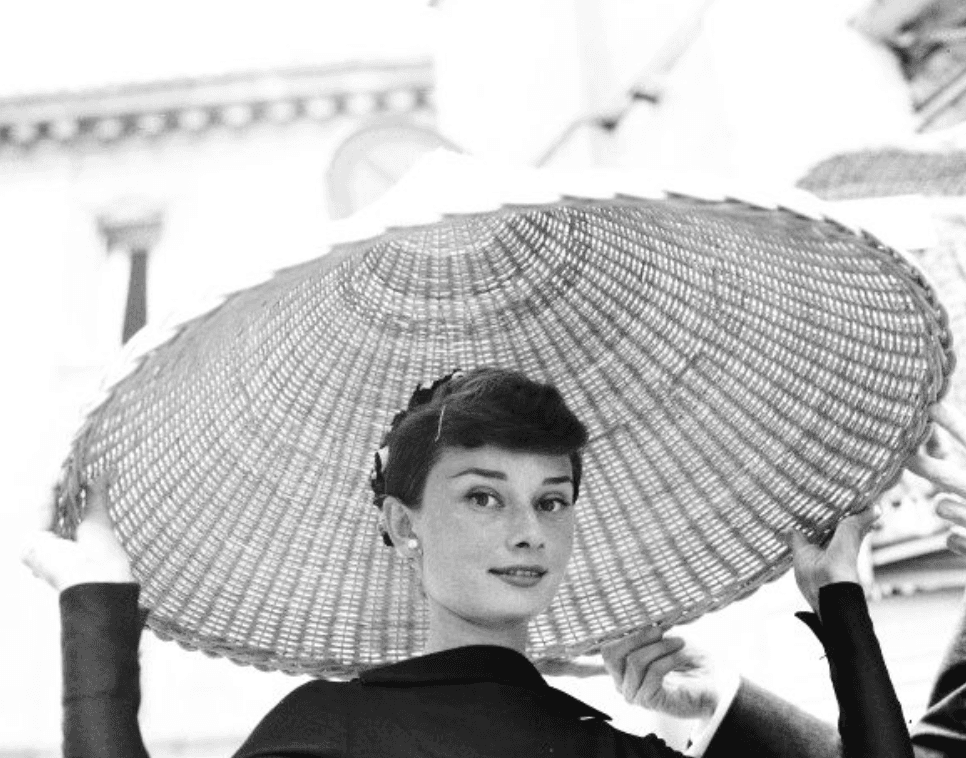 Audrey Hepburn with a wide woven parasol hat