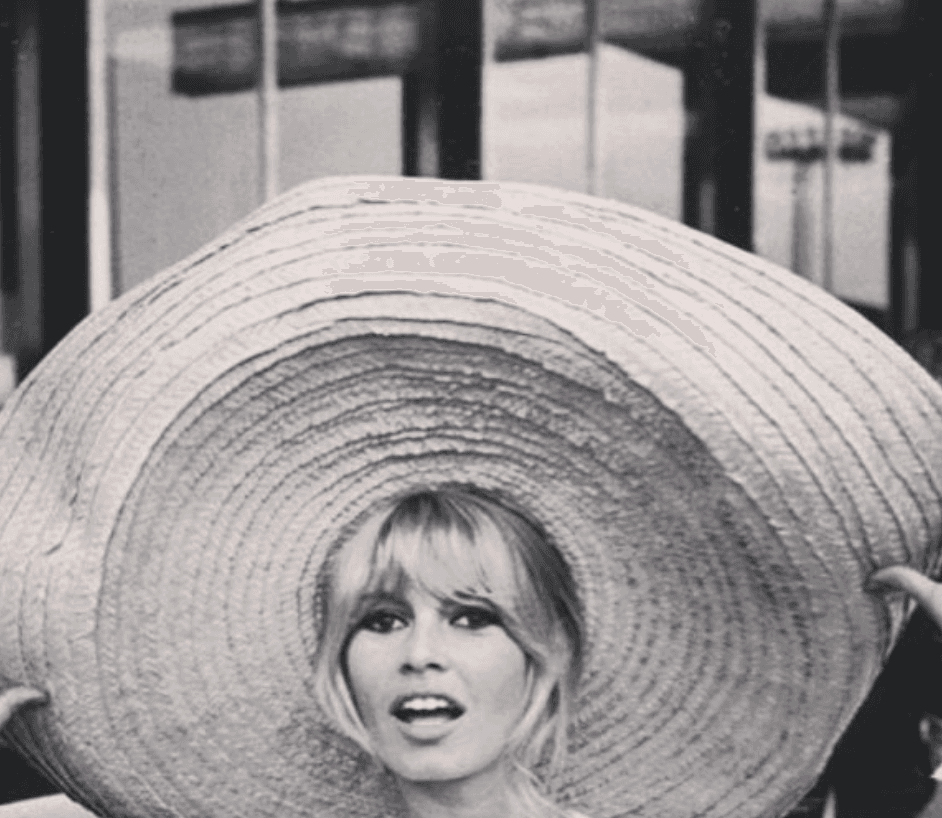 Brigitte Bardot wearing an oversized straw sun hat in the 1960s