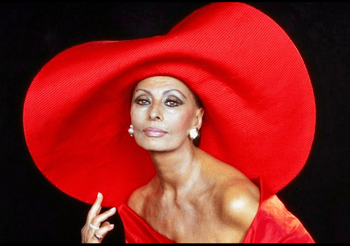 Sophia Loren wearing a dramatic oversized red hat -- classic Old Hollywood glamour